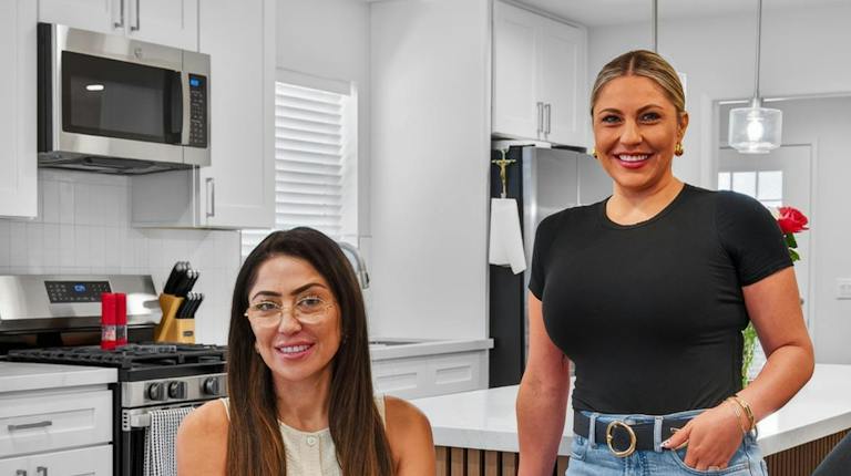 The Mejia Team in a remodeled white kitchen